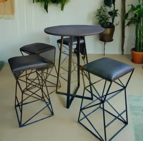 Table with four black leather seat chairs in modern design